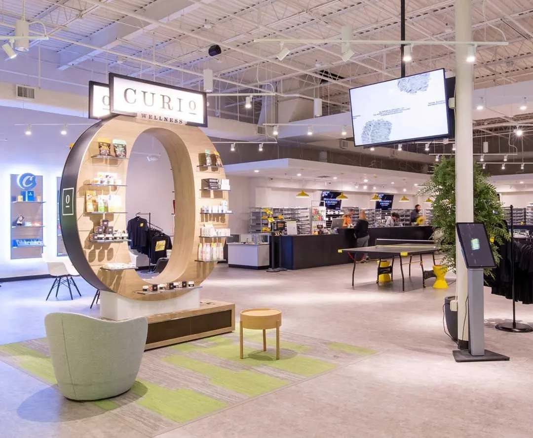 Spacious dispensary showroom with circular Curio product display and seating